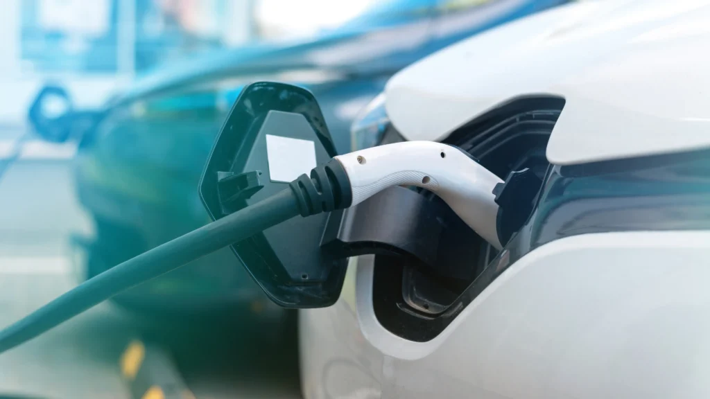 Car with EV charge plugged in closeup